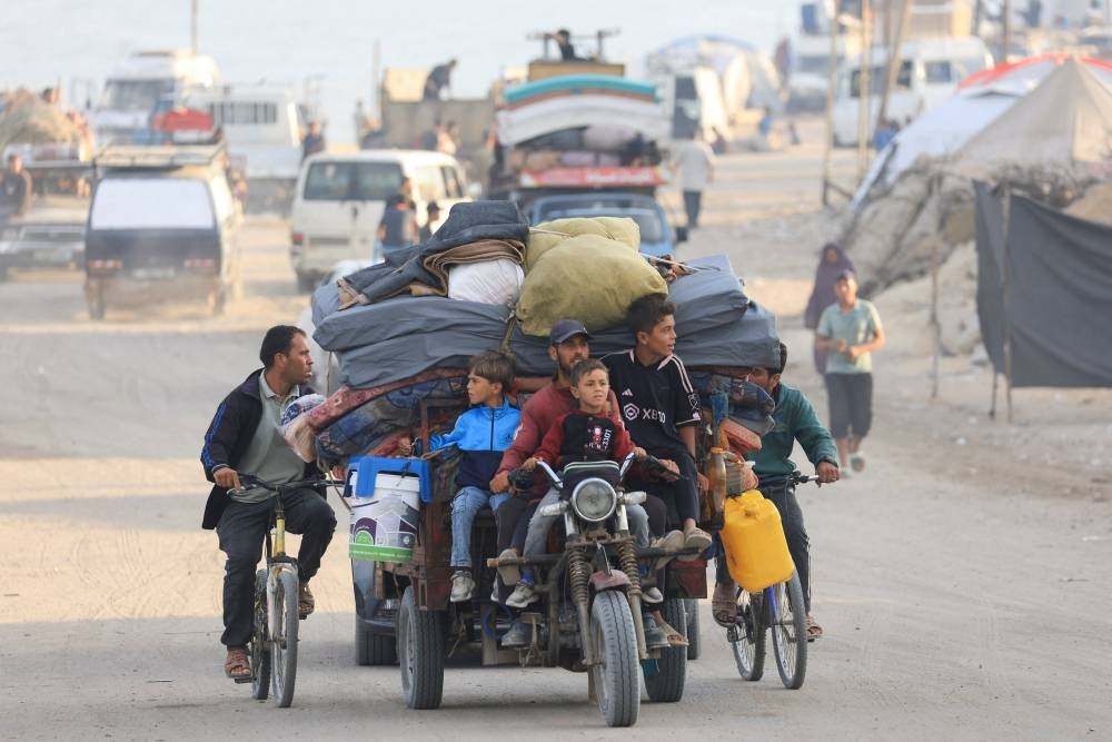 Displaced Palestinians, fleeing northern Gaza due to an Israeli military operation, move southward after Israeli forces ordered residents of Gaza City to evacuate to the south, in the central Gaza Strip, on Wednesday. REUTERS