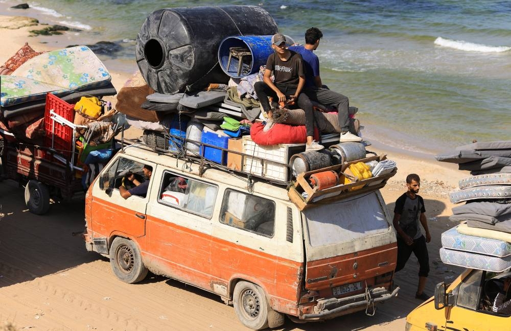 Displaced Palestinians, fleeing northern Gaza due to an Israeli military operation, move southward after Israeli forces ordered residents of Gaza City to evacuate to the south, in the central Gaza Strip, on Wednesday. REUTERS