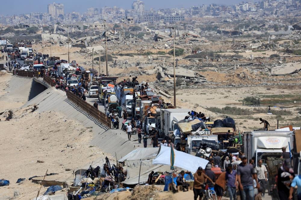 Displaced Palestinians, fleeing northern Gaza due to an Israeli military operation, move southward after Israeli forces ordered residents of Gaza City to evacuate to the south, in the central Gaza Strip, on Wednesday. REUTERS