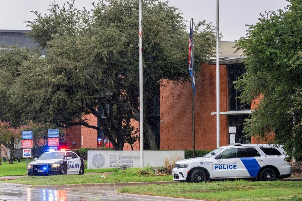 Law enforcement personnel respond at the scene of a shooting at an Immigration and Customs Enforcement (ICE) field office in Dallas, Texas, on Wednesday. REUTERS