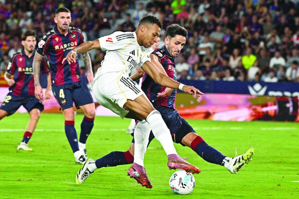 Real Madrid&#039;s French forward #10 Kylian Mbappe fights for the ball with Levante&#039;s Spanish defender #05 Unai Elgezabal during the Spanish league football match between Levante UD and Real Madrid CF at the Ciutat de Valencia stadium in Valencia on Tuesday. AFP