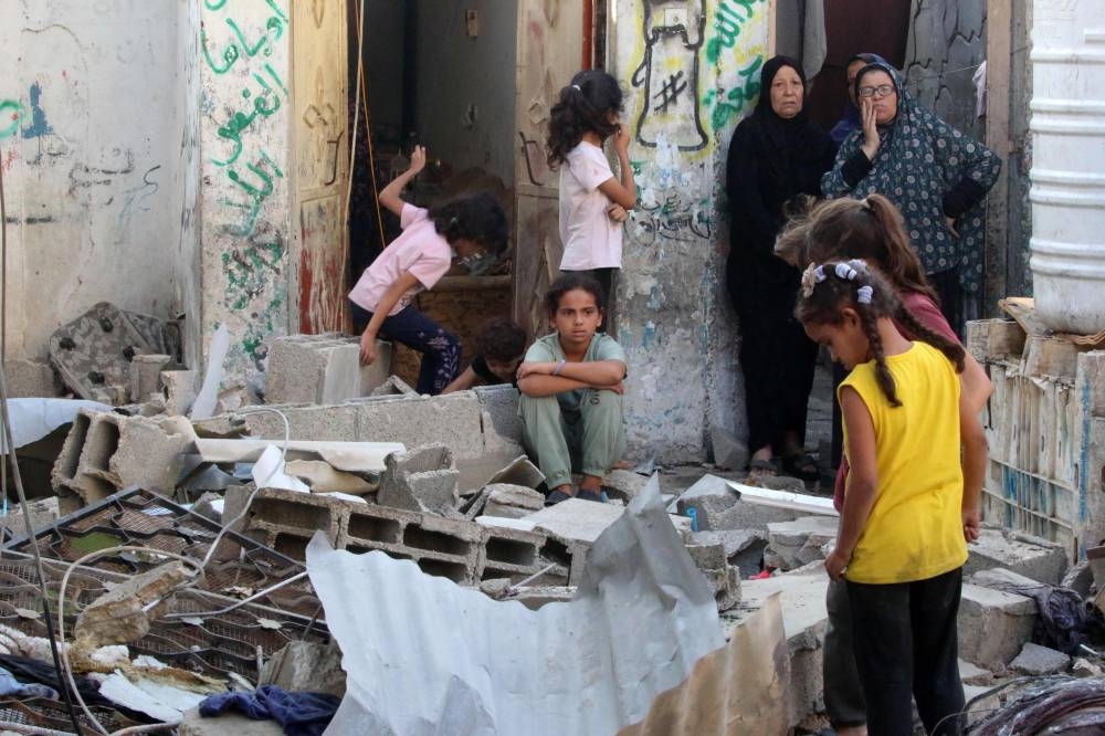 Palestinians check the damage outside a house hit by Israeli bombing in the Nuseirat refugee camp in the central Gaza Strip on Saturday. AFP