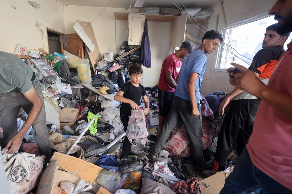 Palestinians check the damage in a room inside a house hit by Israeli bombing in the Nuseirat refugee camp in the central Gaza Strip on Saturday. AFP