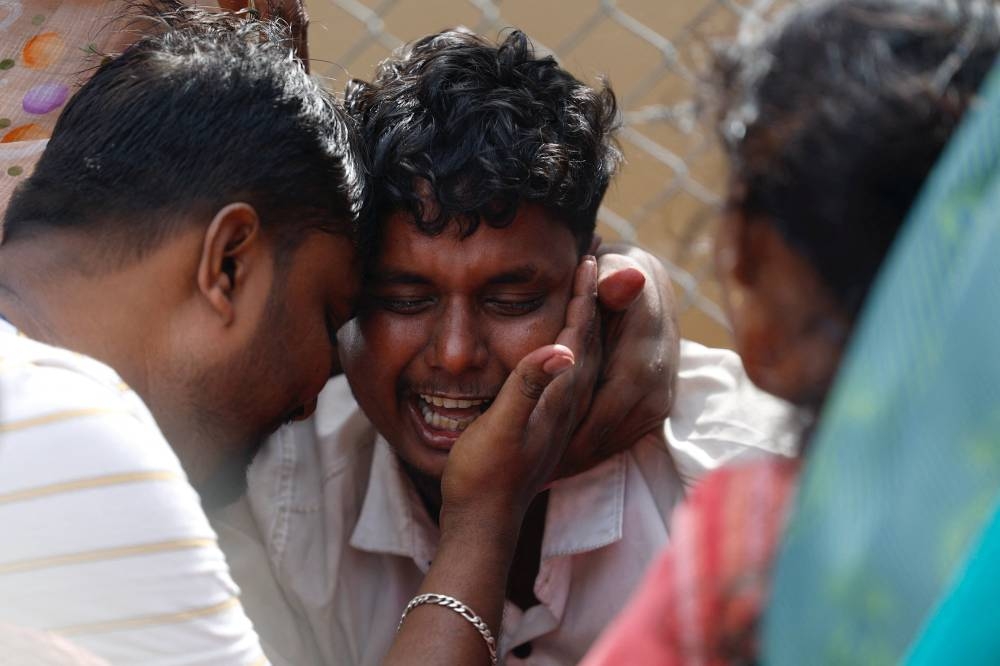 Santosh, who lost his seven-year-old child in a stampede at a election campaign rally held by Tamilaga Vettri Kazhagam, burst into tears in front of Karur Government Medical College as he comes to receive the body, in Karur, India, on Sunday. REUTERS