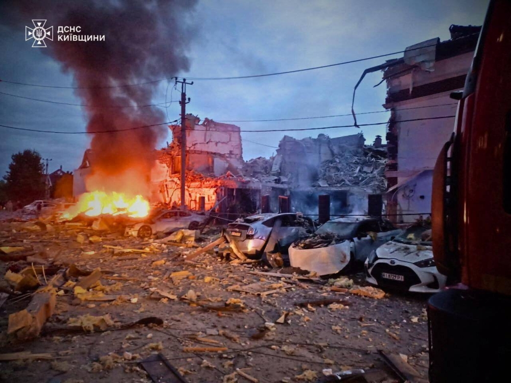 Fire burns at a residential neighbourhood hit by the Russian drone and missile strike in the outskirts of Kyiv, Ukraine, on Sunday. REUTERS