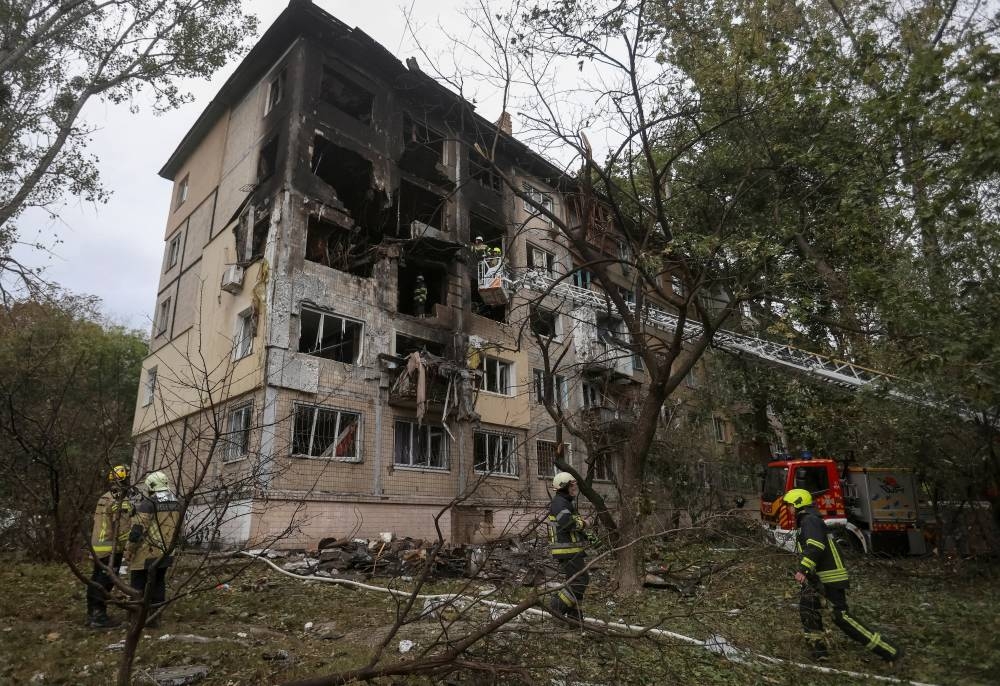 Firefighters work at the site of an apartment building damaged during a Russian drone and missile strike, amid Russia's attack on Ukraine, in Kyiv, Ukraine, on Sunday. REUTERS