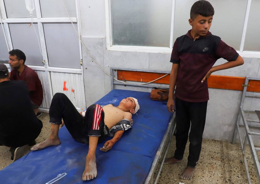 A boy lies on a hospital bed as wounded Palestinians receive treatment at Al-Shifa Hospital after being injured in an Israeli strike, amid an Israeli military operation, according to medics, in Gaza City, on Monday. REUTERS