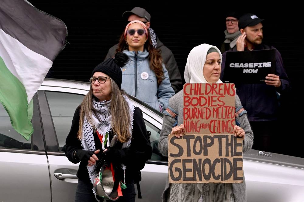 People hold placards at a rally supporting Australians onboard the Global Sumud Flotilla attempting to deliver aid to Gaza and calling on the Australian government's support, in Melbourne on Wednesday. REUTERS