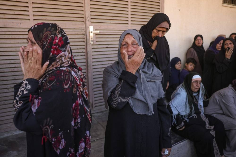 Palestinians mourn the death of loved ones killed in Israeli strikes, outside al-Aqsa Martyrs hospital in Deir el-Balah in the central Gaza Strip, on, on Wednesday. AFP