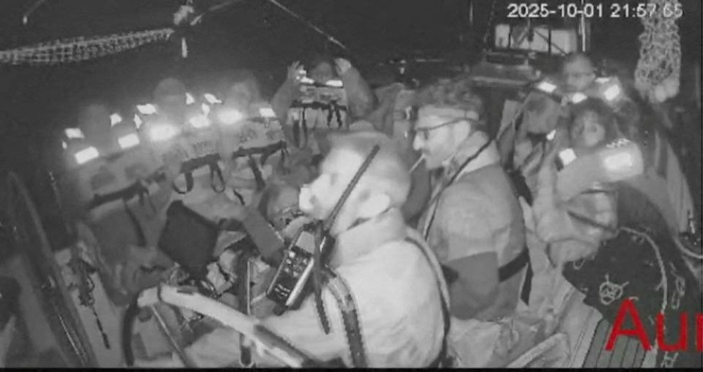 A screengrab from a live video footage shows crew members sitting aboard the Gaza-bound Aurora vessel, part of the Global Sumud Flotilla, October 1, 2025. Global Sumud Flotilla/Handout via REUTERS 