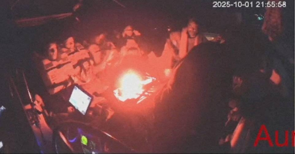 A screengrab from a live video footage shows crew members sitting aboard the Gaza-bound Aurora vessel, part of the Global Sumud Flotilla, October 1, 2025. Global Sumud Flotilla/Handout via REUTERS 