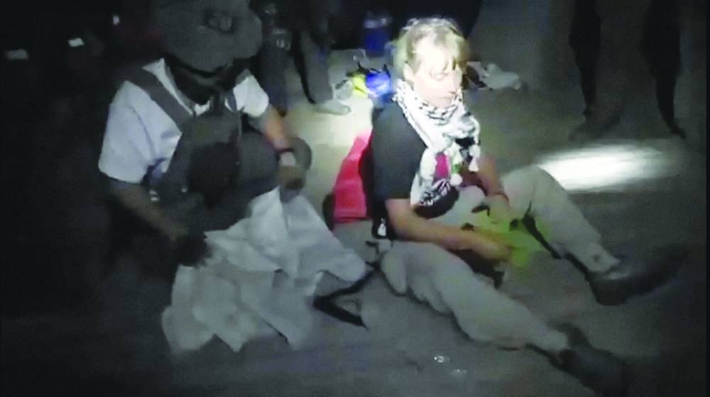 
A screengrab from a video shows Swedish activist Greta Thunberg sitting next to a person wearing tactical gear, as vessels of the Global Sumud Flotilla are being intercepted by Israeli security forces. 