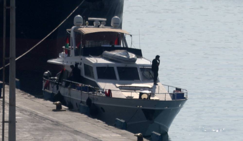 People stand on boat from a flotilla that had been carrying aid to Gaza until it was intercepted by Israel, docked in the port of Larnaca, Cyprus, on Friday. REUTERS