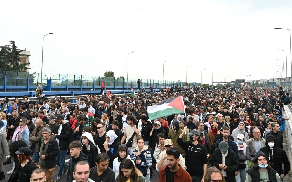Pro-Palestinian demonstrators march during the protest on the Milan's highway against the interception of the Global Sumud Flotilla, on Friday. AFP