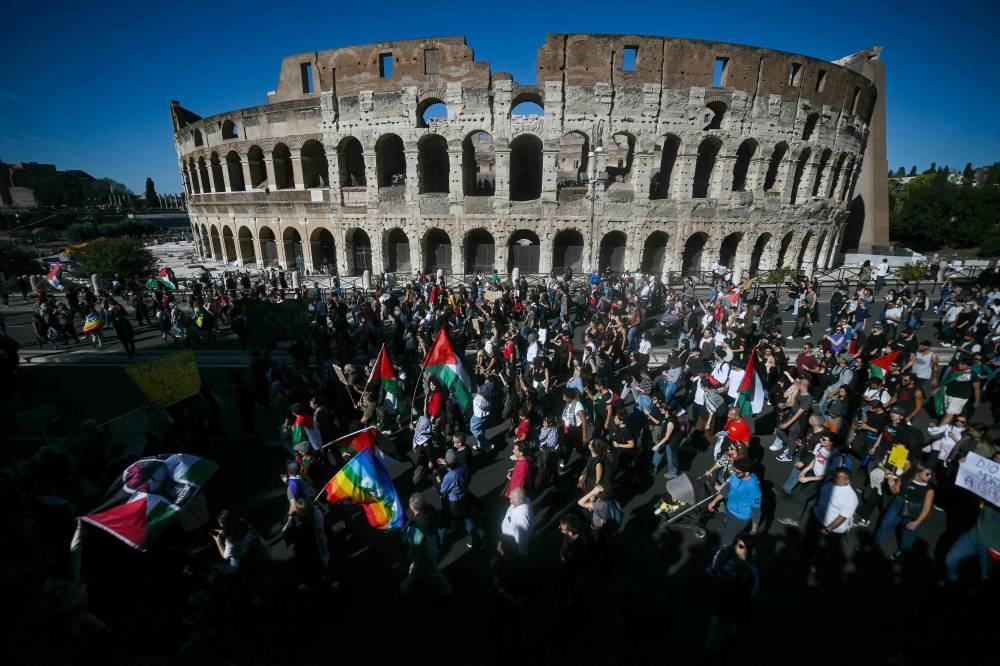 Pro-Palestinian demonstrators march past the Colosseum as they take part in a protest in support of the Palestinian people and against Israel's interception of the Global Sumud Flotilla, in Rome on Saturday. AFP