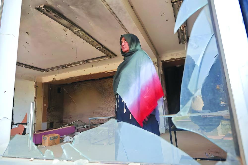 Rehab Kheder al-Rasheed, Head of the Committee to Evaluate Damage, Risk, and Secure Museums and Archaeological Sites, stands inside a damaged hall at the Sudan National Museum, which suffered extensive destruction and looting amid the ongoing conflict between the paramilitary Rapid Support Forces (RSF) and the Sudanese army, in Khartoum, Sudan.