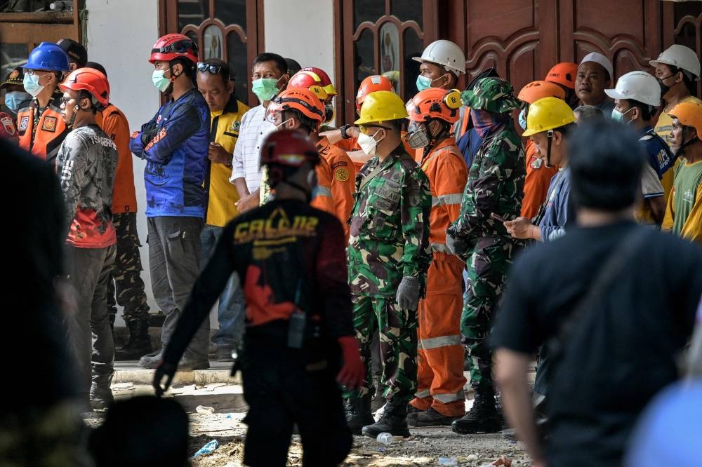 Rescuers search for victims at the Al Khoziny Islamic boarding school in Sidoarjo, East Java, on Sunday. AFP