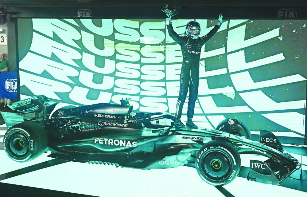 Mercedes' British driver George Russell celebrates his victory after the Singapore Grand Prix night race at the Marina Bay Street Circuit in Singapore Sunday. AFP