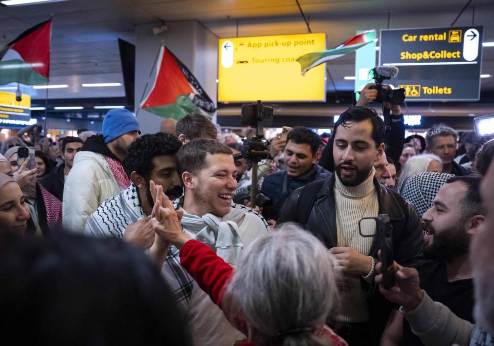 Four Dutch activists, who were among the hundreds stopped and detained by Israeli forces sailing aboard vessels from the Gaza-bound aid flotilla, are greeted by supporters upon their return to Schiphol Airport on Monday. AFP