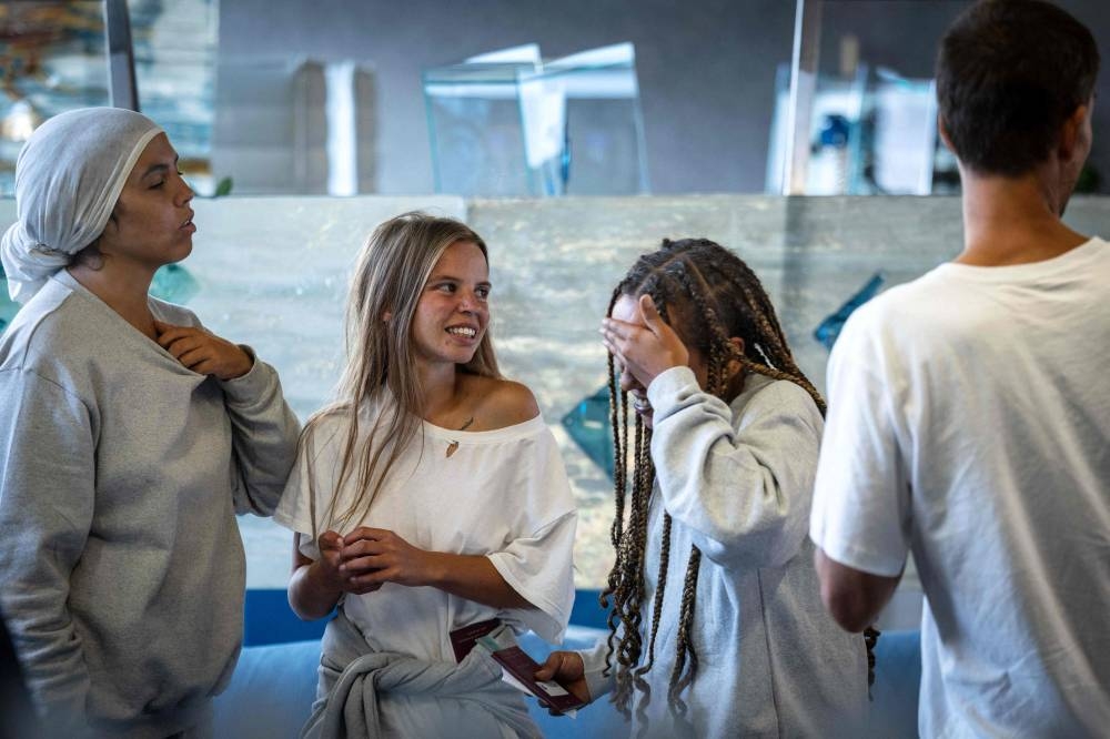 Participants of the Global Sumud Flotilla react upon arrival at the airport in Bratislava, Slovakia on Monday. AFP