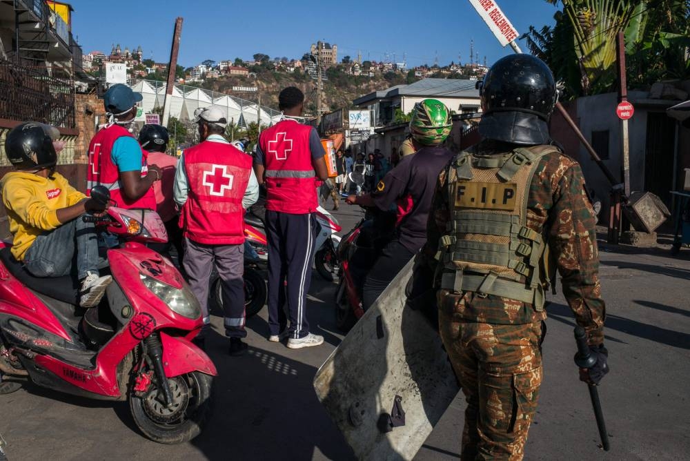 Members of the Malagasy Red Cross are deployed near a protest to assist and treat possible injuries in Antananarivo, on Sunday. AFP