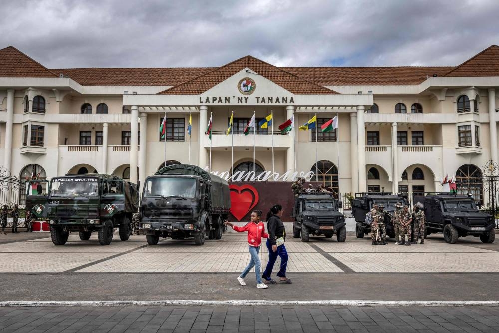 Members of the Malagasy Army stand with their vehicles guarding the facade of city hall in Antananarivo, on Sunday. AFP