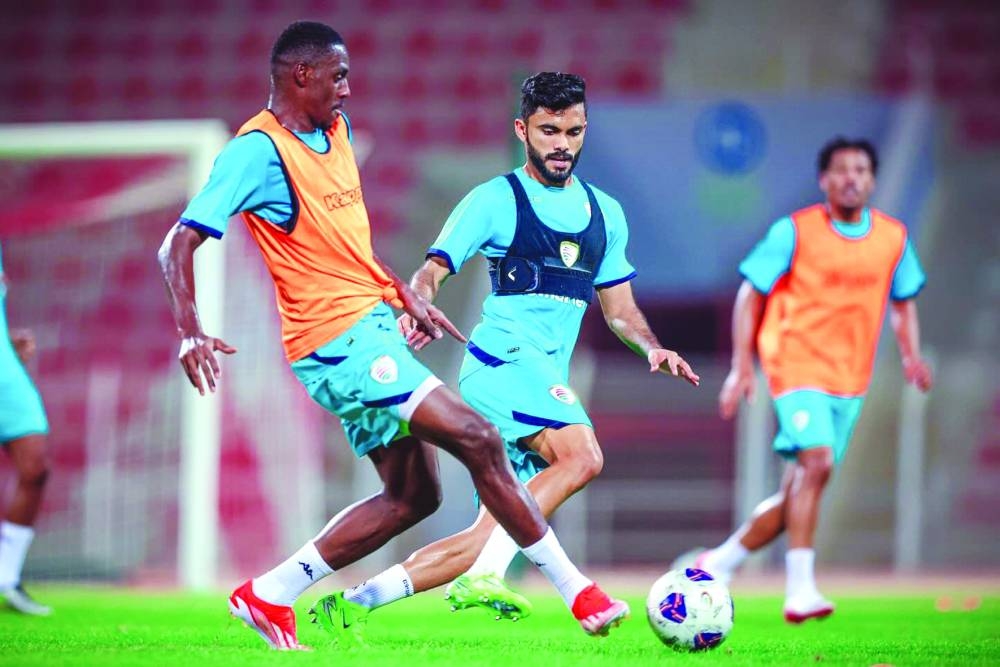 Oman players train ahead of their match against Qatar.