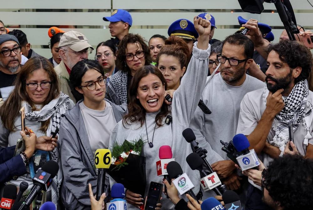 Mexican activist Laura Alejandra Velez, with Sol Gonzalez, Arlin Medrano, Ernesto Ledesma and Diego Vazquez, gestures as she speaks to the media upon arriving at Mexico City International Airport with other Mexican activists who were part of the Global Sumud Flotilla, which sought to deliver aid to Gaza and were detained by Israeli forces, in Mexico City, on Wednesday. REUTERS