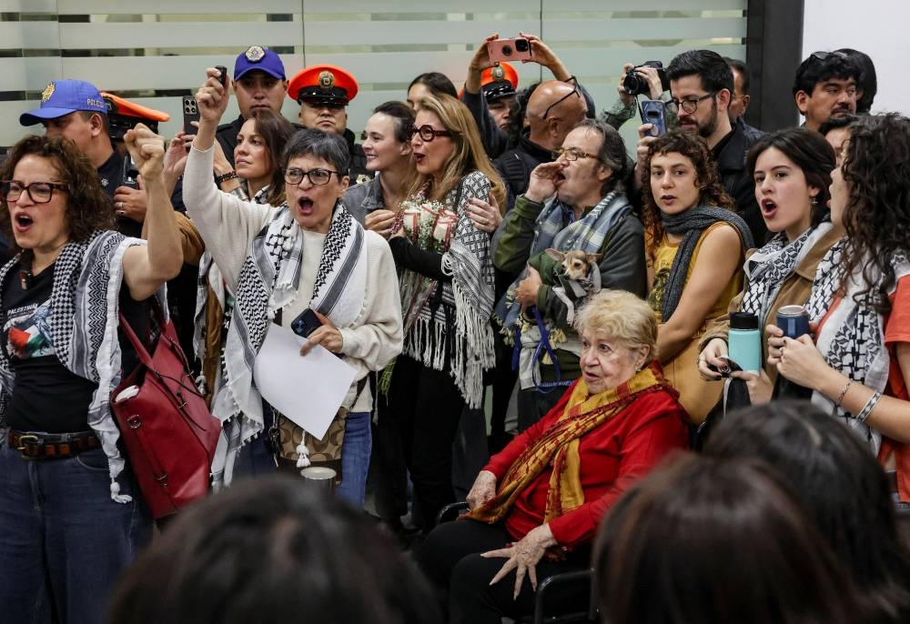 Family members of the Mexican activists who were part of the Global Sumud Flotilla, which sought to deliver aid to Gaza and were detained by Israeli forces, chant slogans as the activists arrive in Mexico City, on Wednesday. REUTERS
