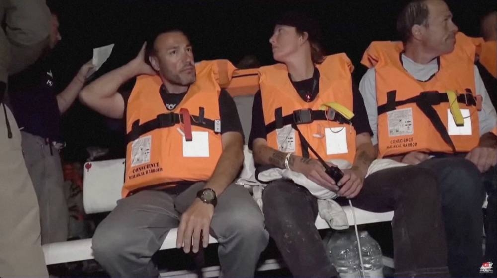 Crew of "Conscience", a Gaza-bound vessel which is part of the Global Sumud Flotilla, sit aboard the boat as they are intercepted by Israeli security forces, in this screengrab obtained from a video released on Wednesday. IHH/Handout via REUTERS