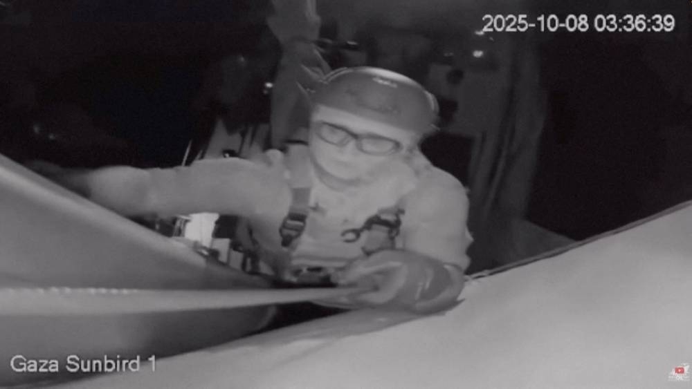 A screengrab from a live footage video shows an Israeli soldier smashing the CCTV camera of "Gaza Sunbird", a Gaza-bound vessel which is part of the Global Sumud Flotilla, with a gun as the boat is intercepted by Israeli security forces, in this screengrab obtained from a video released on Wednesday. Freedom Flotilla Coalition/Handout via REUTERS