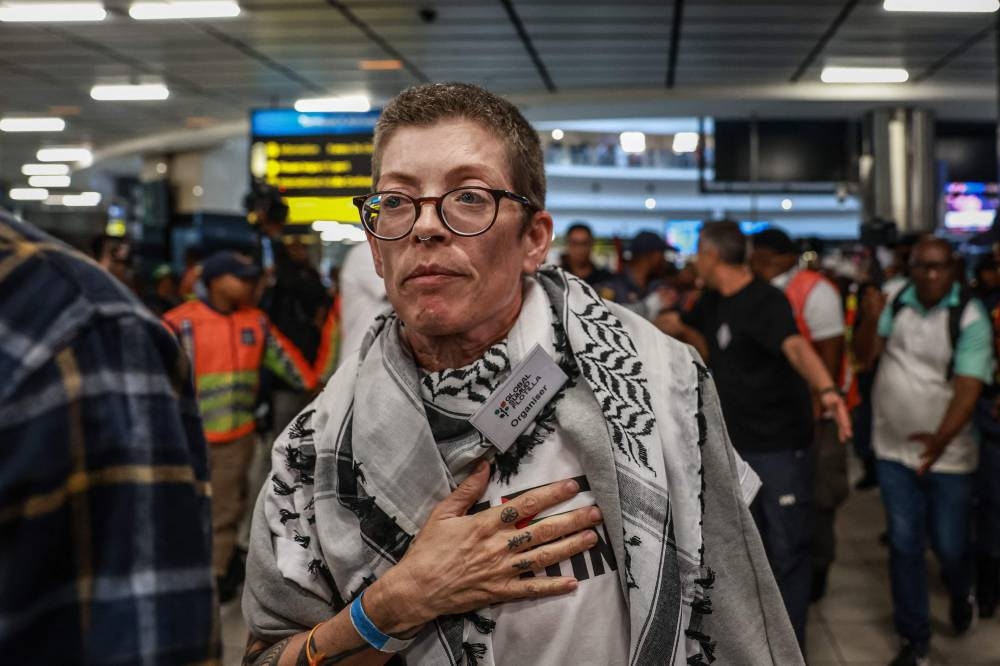 South African activist Carolyn Shelver reacts as she arrives with others at OR Tambo International Airport in Kempton Park on Wednesday after being stopped, detained and later released by Israeli forces while sailing aboard vessels from the Gaza-bound aid flotilla. AFP