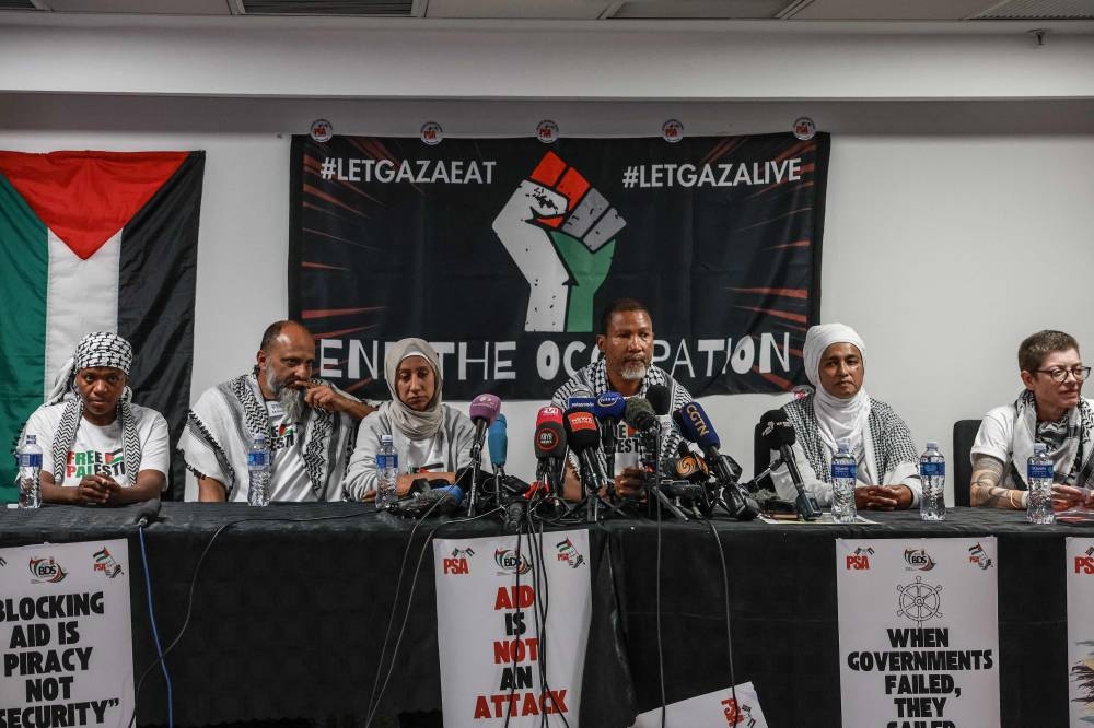 Mandla Mandela (CR), South African activist and grandson of the late Nelson Mandela reacts as he conducts a press conference with Zaheera Soomar (CL), Fatima Hendricks (2nd R), Carolyn Shelver (R), Reaaz Moola (2nd L) and Zukiswa Wanner (L) after arriving at OR Tambo International Airport in Kempton Park on Wednesday after being stopped, detained and later released by Israeli forces while sailing aboard vessels from the Gaza-bound aid flotilla. AFP