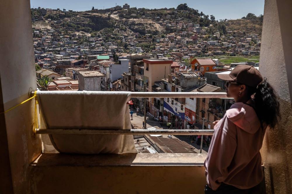 A student from the University of Ankatso looks out over the city from a dormitory affected by recurring water and power shortages in Antananarivo, on Wednesday. AFP