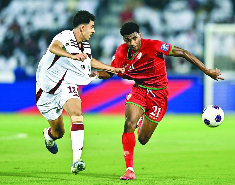 Qatar's debutant Ayoub Aloui (left) and Oman's Abdul Rahman al-Mushaifri battle for the ball at the Jassim Bin Hamad Stadium Wednesday. PICTURES: Noushad Thekkayil