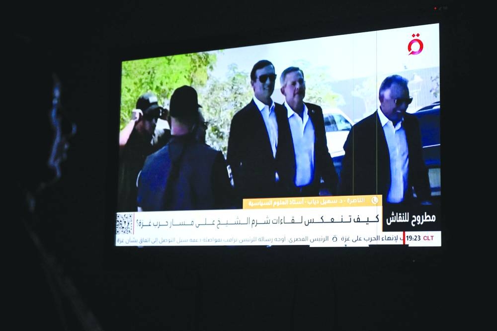A local channel in Cairo shows images of Witkoff (R) and Kushner (C) arriving in Sharm El-Sheikh for talks on ending the Gaza war.