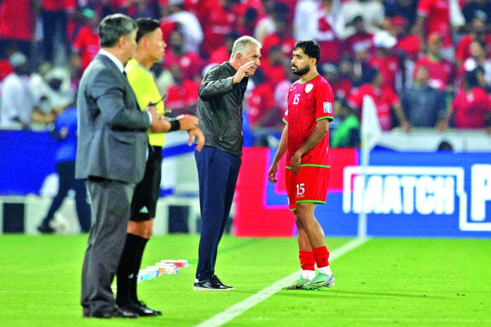 Oman&#039;s Portuguese coach Carlos Queiroz speaks with Oman&#039;s midfielder #15 Nasser Al-Rawahi during the FIFA World Cup 2026 Asian qualifier football match between Qatar and Oman at Jassim Bin Hamad Stadium in Doha on October 8, 2025. AFP