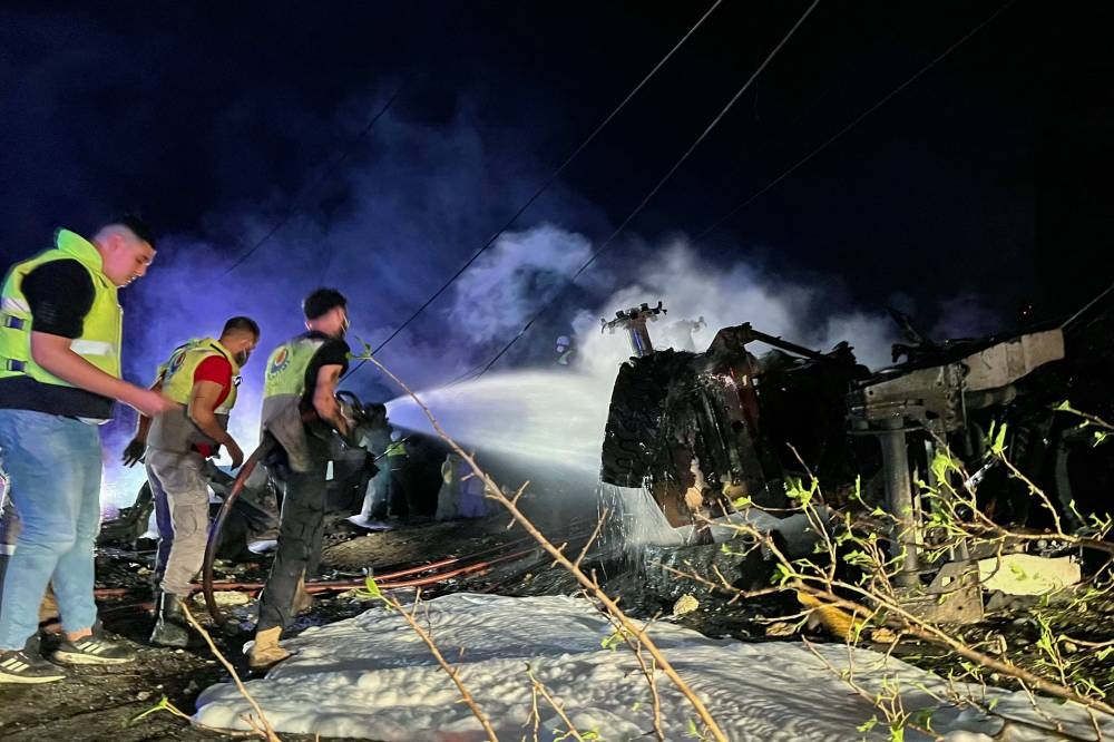 Firefighters douse the flames at the site of an overnight Israeli strike in Al-Msayleh area in southern Lebanon on October 11, 2025. Lebanese President Joseph Aoun condemned Israel on October 11 for carrying out overnight strikes on civilian facilities that the health ministry said killed at least one person. (AFP)