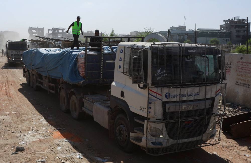 Trucks carry aid for Palestinians, amid a ceasefire between Israel and Hamas in Gaza, in Khan Younis, in the southern Gaza Strip, on Saturday. REUTERS