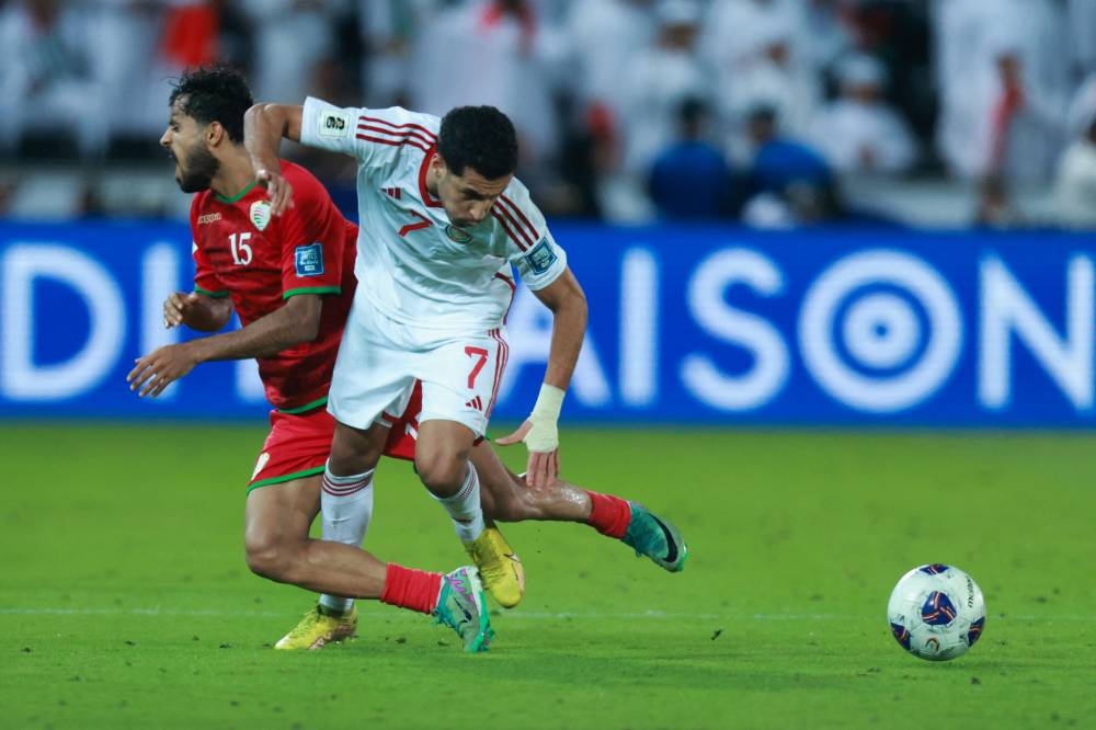 UAE's forward #7 Ali Saleh and Oman's midfielder #15 Nasser Al-Rawahi fight for the ball during the FIFA World Cup 2026 Asian qualifier football match between United Arab Emirates and Oman at Jassim Bin Hamad Stadium in Doha on Saturday. AFP