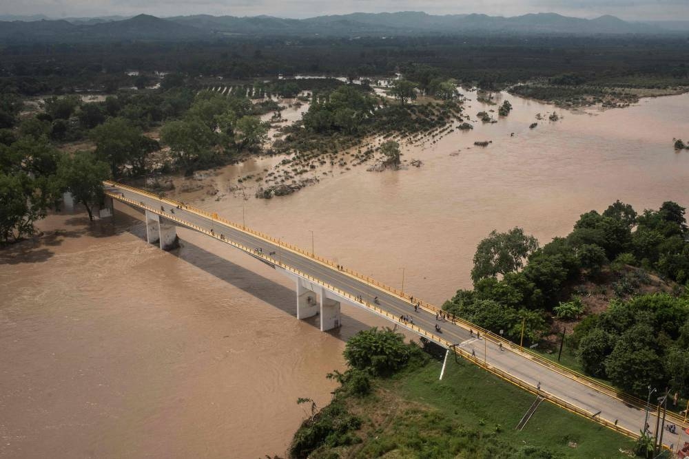 This aerial view taken during a Mexican Navy flyover shows the Cazones River overflowed after heavy rains in Poza Rica, Veracruz state, Mexico, on Sunday. AFP