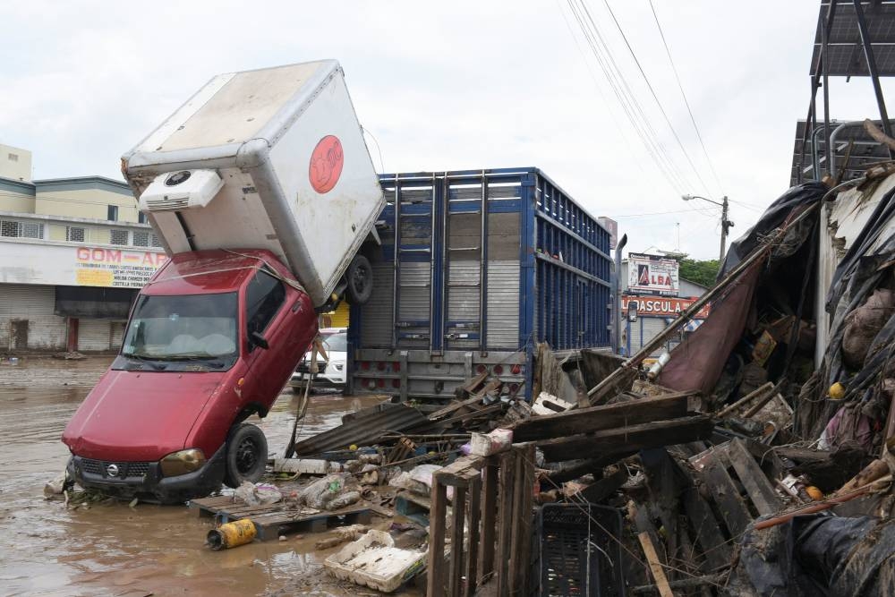 A damaged car swept away by rainwaters after torrential rains overflowed rivers, causing flooding in Poza Rica, Veracruz state, Mexico, on Sunday. REUTERS