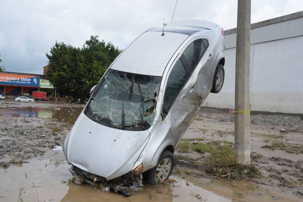 A damaged car swept away by rainwaters after torrential rains overflowed rivers, causing deadly flooding in Poza Rica, Veracruz state, Mexico, on Sunday. REUTERS