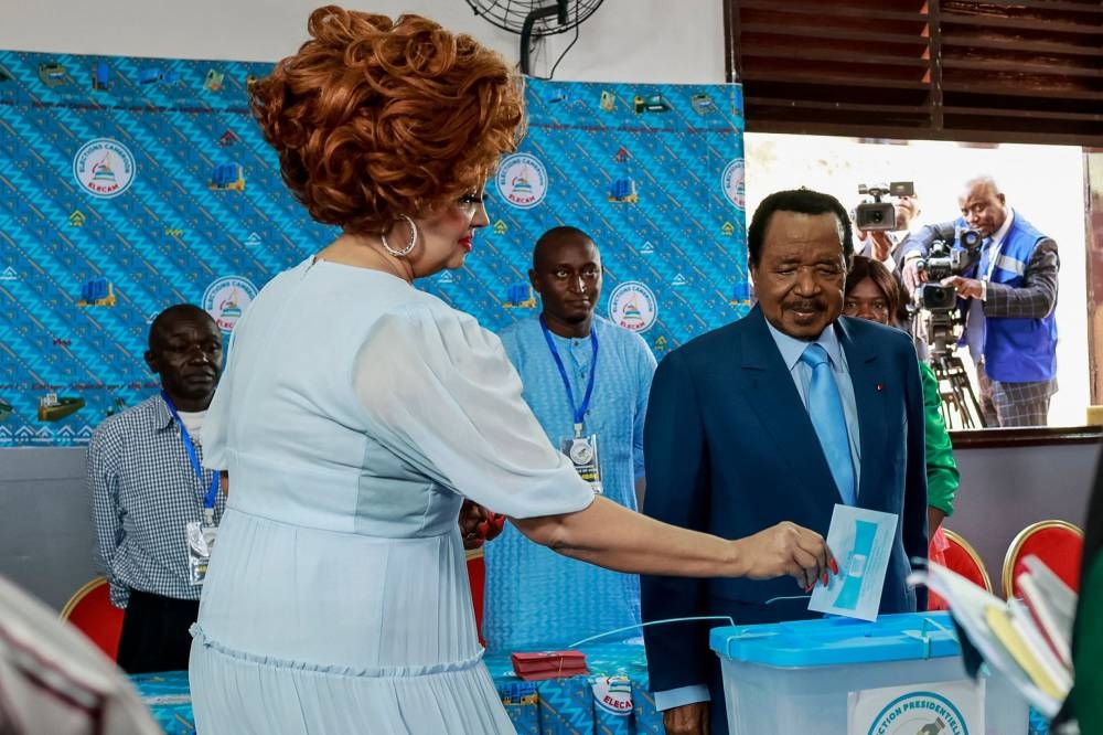 Paul Biya (R), President of Cameroon and presidential candidate for the Cameroon People's Democratic Movement (CPDM), watches as Cameroon First Lady Chantal Biya (L) casts her ballot at a polling station in Yaounde on Sunday during Cameroon's presidential election. AFP