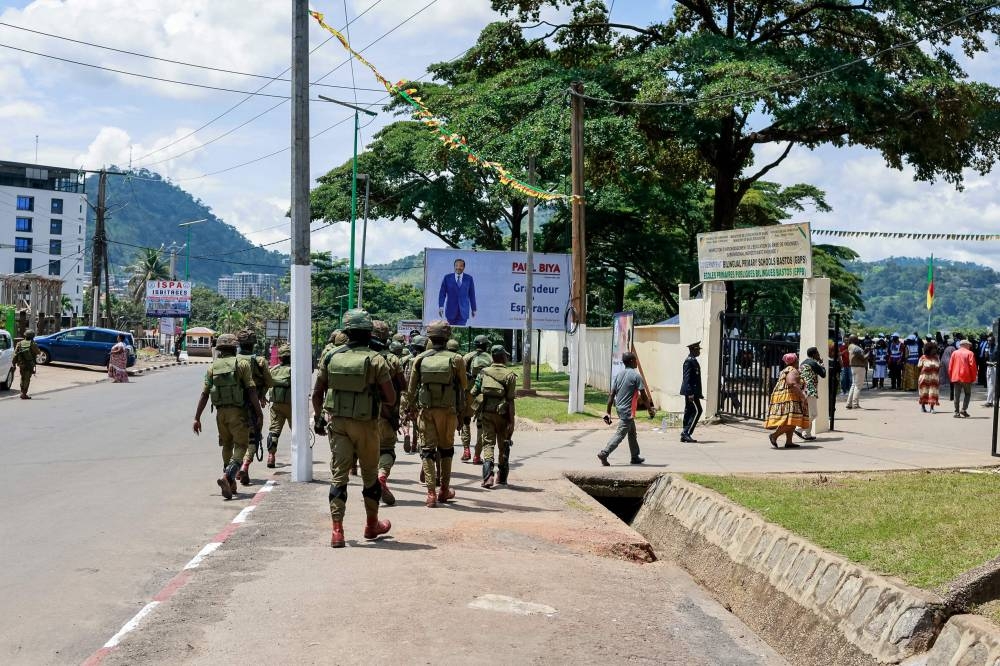 Cameroon soldiers patrol in the street near a polling station in Yaounde on Sunday during Cameroon's presidential election. AFP