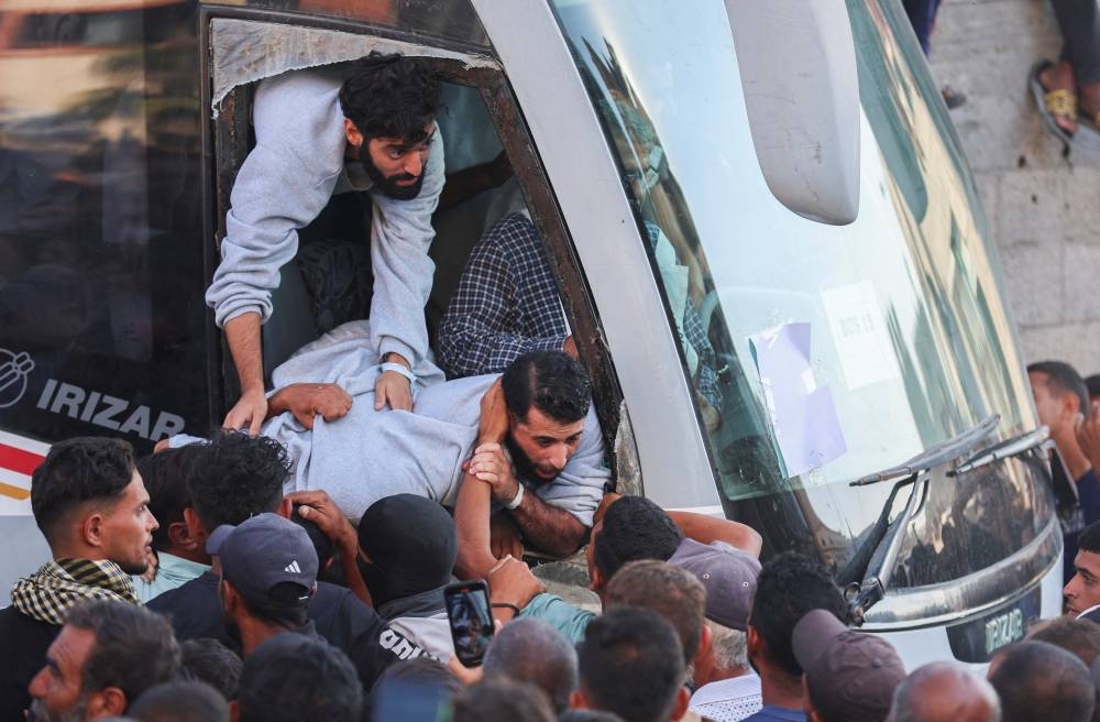Freed Palestinian prisoners released by Israel as part of a hostages-prisoners swap and a ceasefire deal between Hamas and Israel, are welcomed in Khan Younis in the southern Gaza Strip, on Monday. REUTERS