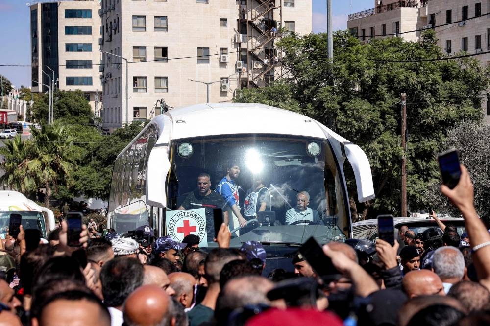One of the buses of the International Committee of the Red Cross (ICRC) carrying Palestinian prisoners released in a prisoner-hostage swap and ceasefire deal between Israel and Hamas arrives at Ramallah Cultural Centre in Ramallah in the occupied West Bank, on Monday. AFP