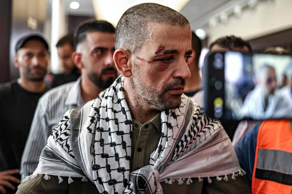 One of the Palestinian prisoners, who was released in a prisoner-hostage swap and ceasefire deal between Israel and Hamas, looks on upon arrival by bus at Ramallah Cultural Centre in Ramallah in the occupied West Bank, on Monday. AFP