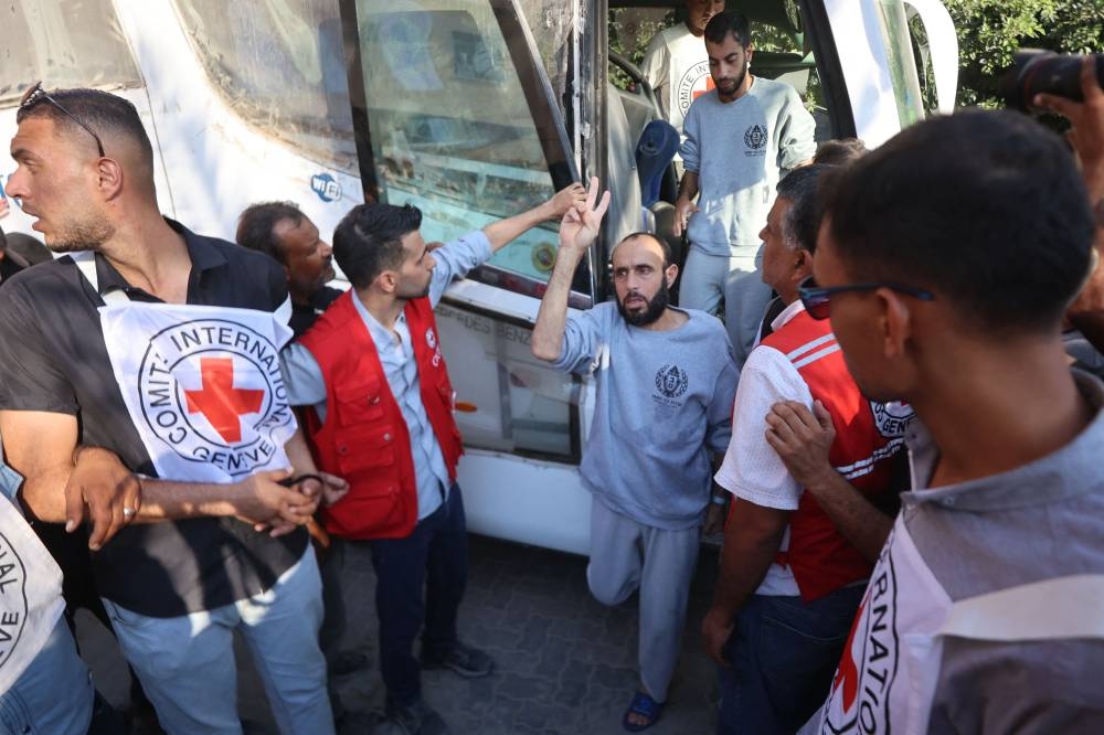 Palestinians released from Israeli prisons under a Gaza ceasefire and hostage exchange deal with Palestinian factions, exit the bus after arriving at the Nasser hospital in Khan Yunis in the southern Gaza Strip on on Monday. AFP