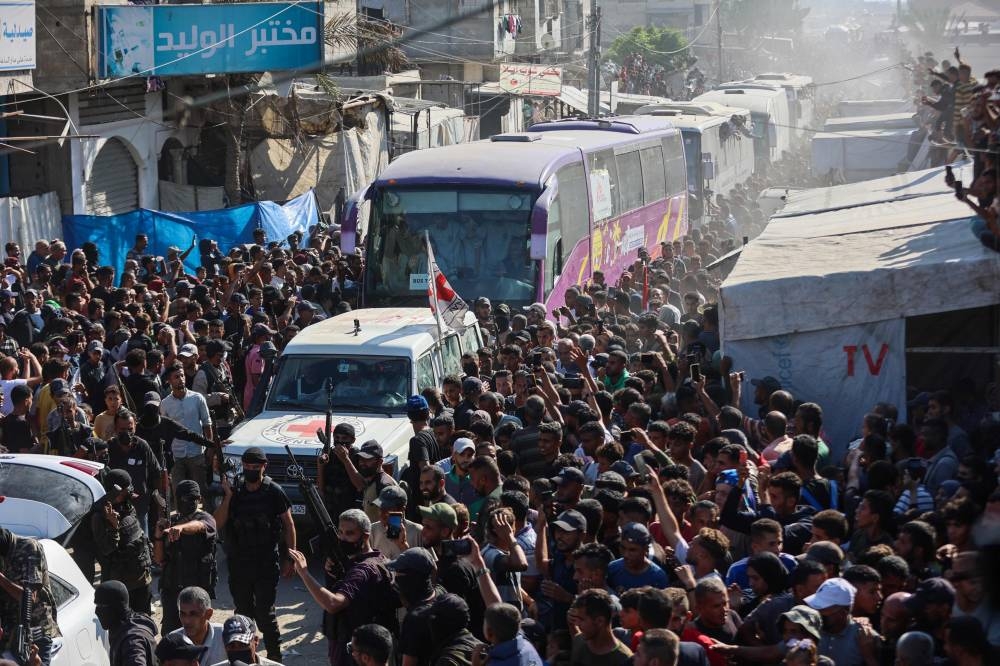 Buses carrying Palestinians released from Israeli prisons under a Gaza ceasefire and hostage exchange deal with Palestinian factions, arrive outside the Nasser hospital in Khan Yunis in the southern Gaza Strip on Monday. AFP